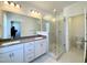 Modern bathroom featuring double vanity, glass shower, and contemporary fixtures at 2353 Whitewing Ln, Wendell, NC 27591