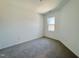 Bright bedroom with neutral carpet and a window providing natural light at 2353 Whitewing Ln, Wendell, NC 27591