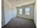 Empty bedroom with plush carpeting and two windows at 2353 Whitewing Ln, Wendell, NC 27591