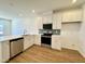 Bright kitchen featuring stainless steel appliances, white cabinets, and a stylish backsplash at 2353 Whitewing Ln, Wendell, NC 27591
