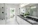 Elegant bathroom featuring double sink vanity with granite countertop, large mirror, and glass shower at 2404 Del Webb Gardens Dr, Fuquay Varina, NC 27526