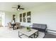 Relaxing covered patio with a ceiling fan, dining table, and comfortable seating area at 2404 Del Webb Gardens Dr, Fuquay Varina, NC 27526