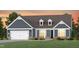 Charming single Gathering home featuring a two-car garage, dormers, and a landscaped front yard at 2404 Del Webb Gardens Dr, Fuquay Varina, NC 27526