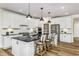Bright kitchen featuring white cabinets, a center island with seating, and stainless steel appliances at 2404 Del Webb Gardens Dr, Fuquay Varina, NC 27526