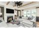 Cozy living room with a fireplace, exposed wood beams, and comfortable seating arrangement at 2404 Del Webb Gardens Dr, Fuquay Varina, NC 27526