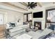 Inviting living room featuring a fireplace, wood beam ceiling accents, and a comfortable sectional sofa at 2404 Del Webb Gardens Dr, Fuquay Varina, NC 27526