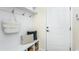 Charming mud room with convenient hooks, storage bench, and a bright white door at 2404 Del Webb Gardens Dr, Fuquay Varina, NC 27526