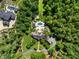 Distant aerial view of estate's house, landscaping, driveway, and surrounding forest at 266 Perfect Moment Dr, Durham, NC 27713
