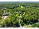 Luxury home surrounded by lush green trees with winding driveway and well manicured lawn, creating a private oasis at 266 Perfect Moment Dr, Durham, NC 27713