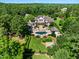 Aerial view showcasing a luxurious estate with a pool, manicured grounds, and surrounding lush greenery at 266 Perfect Moment Dr, Durham, NC 27713