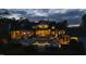 Backyard dusk view of pool, house, and outdoor lighting at 266 Perfect Moment Dr, Durham, NC 27713