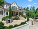 Luxury estate featuring a beautiful backyard patio with outdoor dining area, steps leading to covered porch and lush landscaping at 266 Perfect Moment Dr, Durham, NC 27713