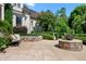 Backyard with an outdoor seating area, fire pit, jacuzzi, and lush greenery creating a serene oasis at 266 Perfect Moment Dr, Durham, NC 27713