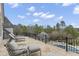 Luxury balcony with seating overlooks manicured backyard with pool, gazebo, and wooded view at 266 Perfect Moment Dr, Durham, NC 27713