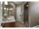 Bathroom featuring stylish vanity with quartz counters, decorative mirror, and large glass shower at 266 Perfect Moment Dr, Durham, NC 27713