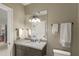 Neutral bathroom with stylish vanity, quartz countertop, decorative lighting, and soft towels at 266 Perfect Moment Dr, Durham, NC 27713