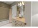 Bathroom featuring a bathtub with shower, a vanity, and cream walls with decorative wallpaper at 266 Perfect Moment Dr, Durham, NC 27713