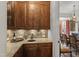 Butler's pantry featuring wood cabinets, granite counters, and tile backsplash at 266 Perfect Moment Dr, Durham, NC 27713