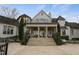 Elegant home exterior with a spacious patio, manicured landscaping, and classic architectural details, perfect for outdoor living at 266 Perfect Moment Dr, Durham, NC 27713