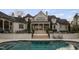 Beautiful home exterior featuring a grand staircase leading to the backyard pool and patio area, ideal for relaxing and entertaining at 266 Perfect Moment Dr, Durham, NC 27713