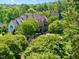 Distant aerial view of home highlighting the exterior, roof, and lush surroundings at 266 Perfect Moment Dr, Durham, NC 27713