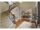 Spacious foyer with curved staircase, wood floors, and elegant dining room view at 266 Perfect Moment Dr, Durham, NC 27713