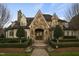 Charming stone home featuring a detailed arched entryway and manicured landscaping at 266 Perfect Moment Dr, Durham, NC 27713