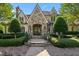 Stunning stone home featuring manicured landscaping, arched entry, and elegant architectural details at 266 Perfect Moment Dr, Durham, NC 27713