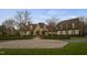 Stately stone and white brick home with mature landscaping and circular driveway at 266 Perfect Moment Dr, Durham, NC 27713