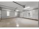 Spacious garage with epoxy floors, custom built-ins, storage cabinets, and bright lighting at 266 Perfect Moment Dr, Durham, NC 27713