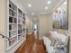Hallway features wood flooring, built-in bookshelves, and elegant decor at 266 Perfect Moment Dr, Durham, NC 27713