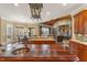 Open-concept kitchen and dining area with hardwood floors, custom cabinets, granite countertops, and a view to the living room at 266 Perfect Moment Dr, Durham, NC 27713