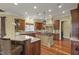 Open kitchen with custom cabinets, center island, bar seating, and hardwood floors at 266 Perfect Moment Dr, Durham, NC 27713