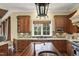 Well-appointed kitchen with granite countertops, island sink, and custom cabinets at 266 Perfect Moment Dr, Durham, NC 27713