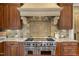 Chef's kitchen featuring a professional range, custom cabinetry, and tile backsplash at 266 Perfect Moment Dr, Durham, NC 27713