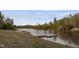 Scenic view of a serene lake with a wooden dock, surrounded by lush trees, offering a peaceful and natural retreat at 266 Perfect Moment Dr, Durham, NC 27713