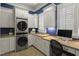 Bright laundry room boasts great cabinetry, countertop space, and high end washer and dryer at 266 Perfect Moment Dr, Durham, NC 27713