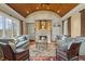 Bright living room boasts a stone fireplace, coffered ceiling and large windows for natural light at 266 Perfect Moment Dr, Durham, NC 27713