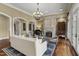 Comfortable living room showcasing a fireplace, chandelier, hardwood floors, and classic décor at 266 Perfect Moment Dr, Durham, NC 27713