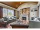 Comfortable living room features a stone fireplace, coffered ceiling and large windows for natural light at 266 Perfect Moment Dr, Durham, NC 27713