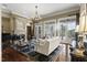 Cozy living room with fireplace, chandelier, hardwood floors, and doors opening to the patio at 266 Perfect Moment Dr, Durham, NC 27713
