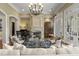 Beautiful living room with fireplace, piano, chandelier, and French doors to the patio at 266 Perfect Moment Dr, Durham, NC 27713