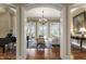 Bright living room boasts a large chandelier, hardwood floors, and access to the outdoor patio at 266 Perfect Moment Dr, Durham, NC 27713
