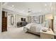 Spacious primary bedroom suite with a large bed, sitting area, and abundant natural light at 266 Perfect Moment Dr, Durham, NC 27713