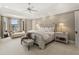 Spacious primary bedroom with a tray ceiling, natural light, sitting area and neutral tones at 266 Perfect Moment Dr, Durham, NC 27713
