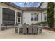 Elegant outdoor dining area with wicker chairs and screened-in porch, perfect for entertaining at 266 Perfect Moment Dr, Durham, NC 27713