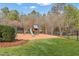 Backyard playground with slide, swings, and fenced-in area at 266 Perfect Moment Dr, Durham, NC 27713