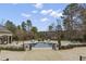 A swimming pool with a water view surrounded by mature trees and manicured greenery at 266 Perfect Moment Dr, Durham, NC 27713