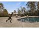 Elegant pool with a statue, sun loungers, and mature landscaping at 266 Perfect Moment Dr, Durham, NC 27713
