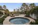An inviting inground pool and spa features a stone fire pit and lush landscaping at 266 Perfect Moment Dr, Durham, NC 27713